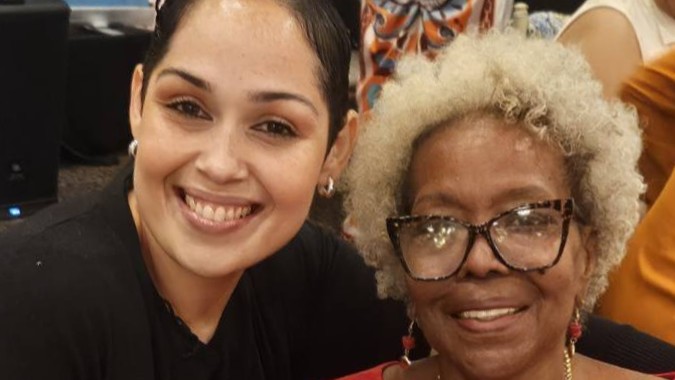 Two women smile for the camera in a candid headshot photo at the Annual RWHC Brunch