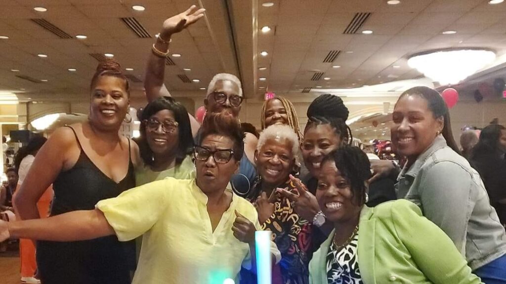 Group of nine women take a candid group photo at 2025 RWHC event